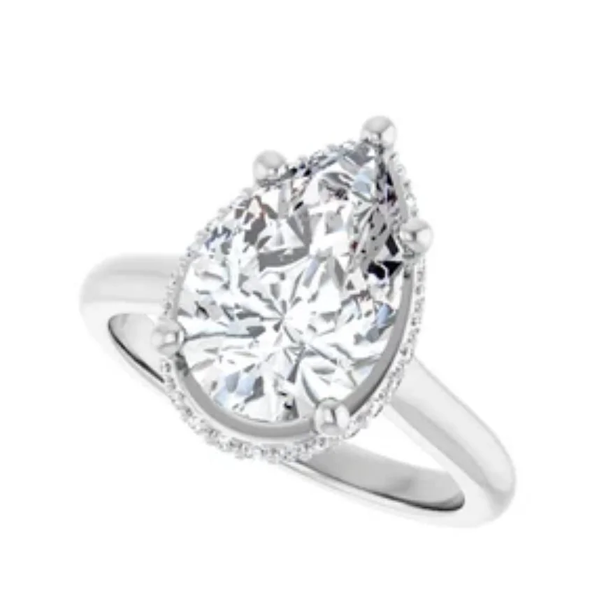 A silver ring with a large, oval-shaped diamond central gemstone surrounded by smaller diamonds.