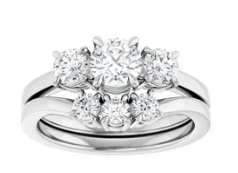 A silver ring with multiple sparkling diamonds arranged in a floral pattern.