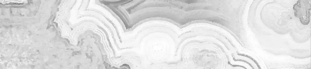 Close-up of a grey and white layered marble surface used with a decorative purpose .