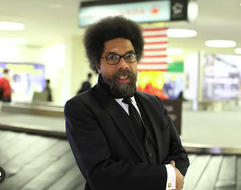 Dr. Cornel West standing at an airport terminal.