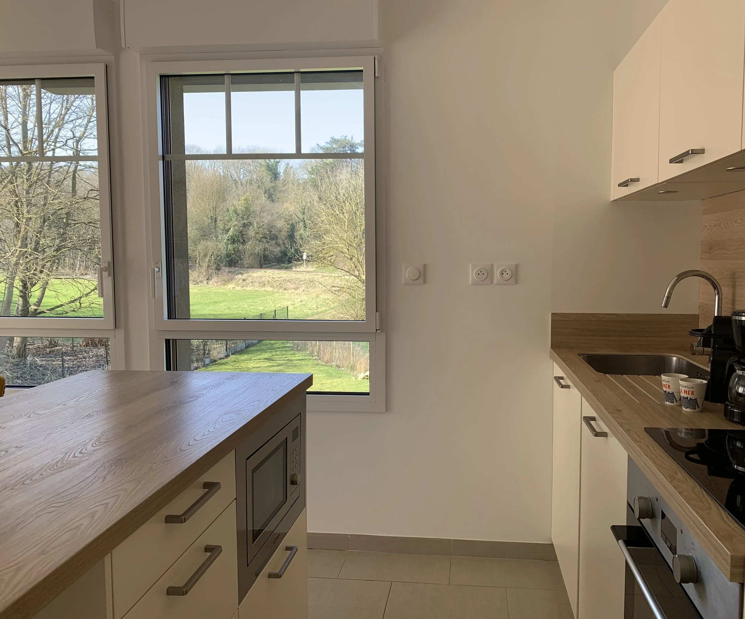 Cuisine tout équipée avec table-bar et chaises hautes