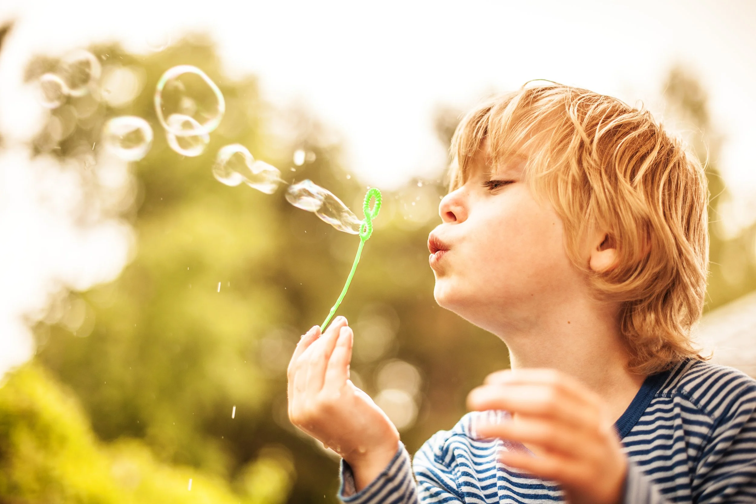 a boy blowing bubbles