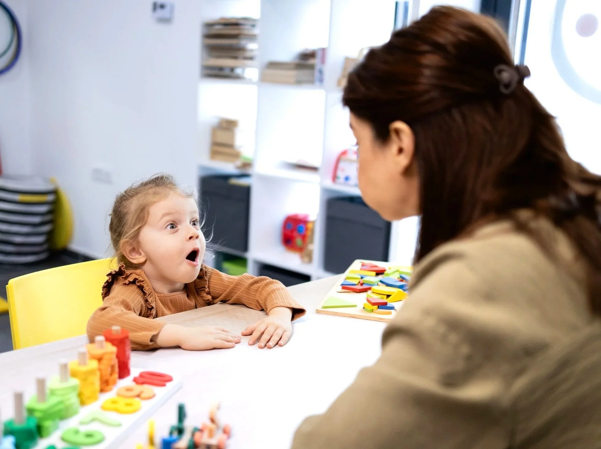 Woman working with child on speech therapy