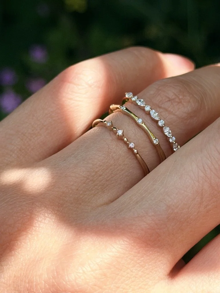 Constellation lab-grown diamond ring in 9ct yellow gold stacked with other rings from The Minimal Stack Edit, worn on the hand. Gugunava Jewelry, London.