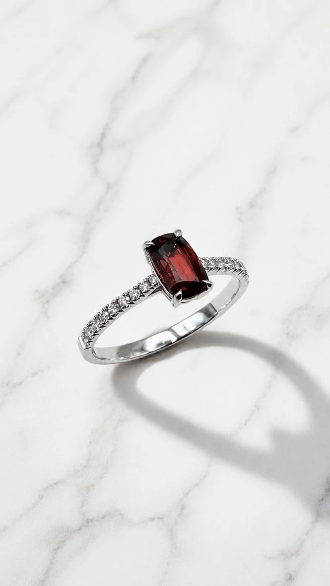 Fire Blossom on marble — cushion-cut red spinel solitaire ring, 14K white gold micro-pavé band, handcrafted in London by Gugunava Jewelry
