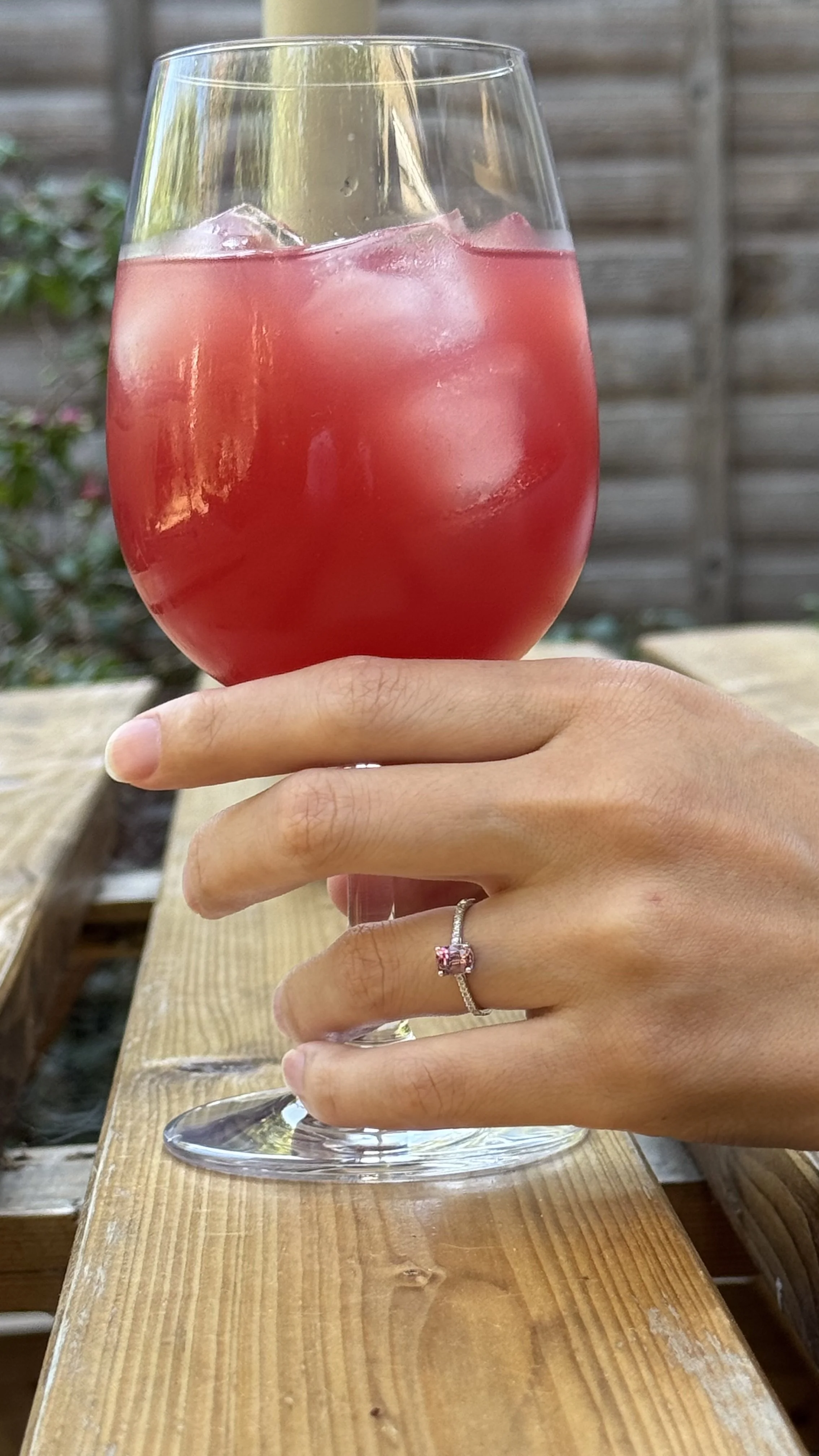 Sakura Blossom pink spinel ring in 14K white gold, worn on the hand outdoors.
