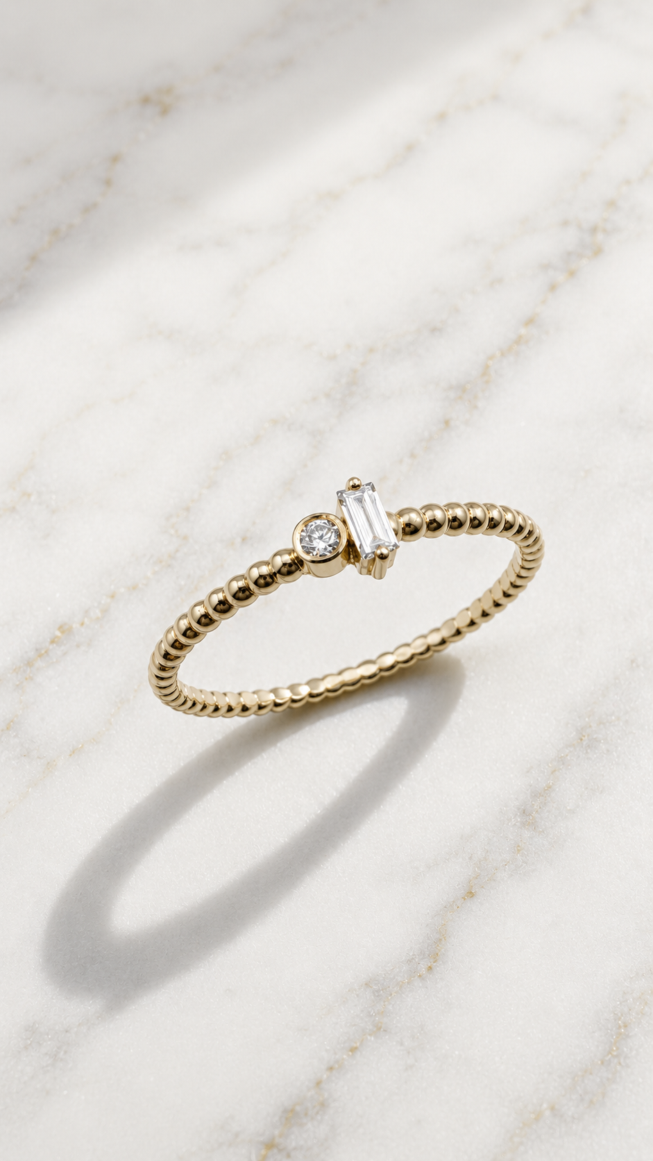 Two stone lab-grown diamond ring in 9ct yellow gold — a baguette and round brilliant set side by side on a beaded band. The Minimal Stack Edit, Gugunava Jewelry, London.
