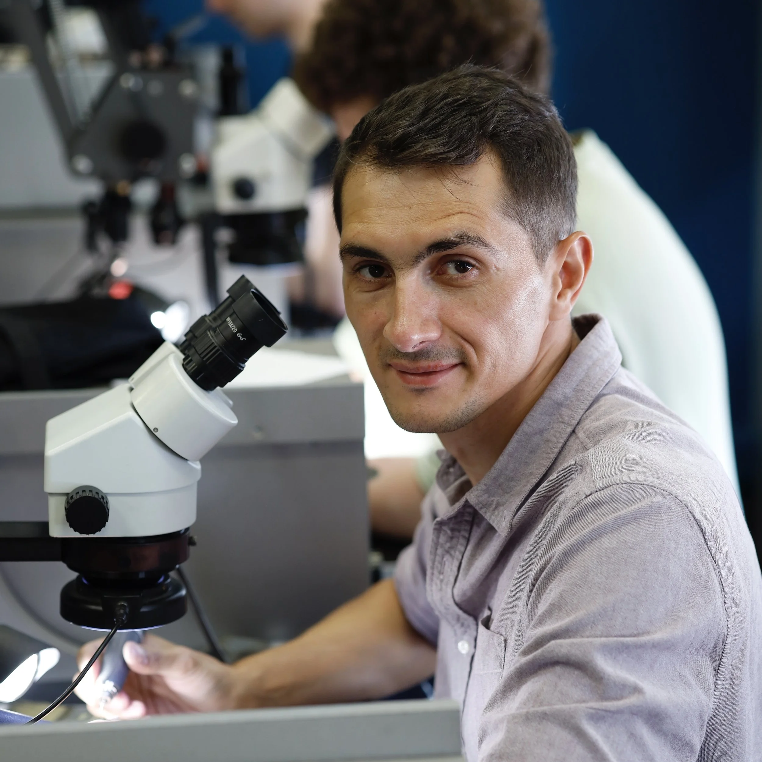 Arsen Gugunava at the microscope in his London workshop, jeweller and stone setter
