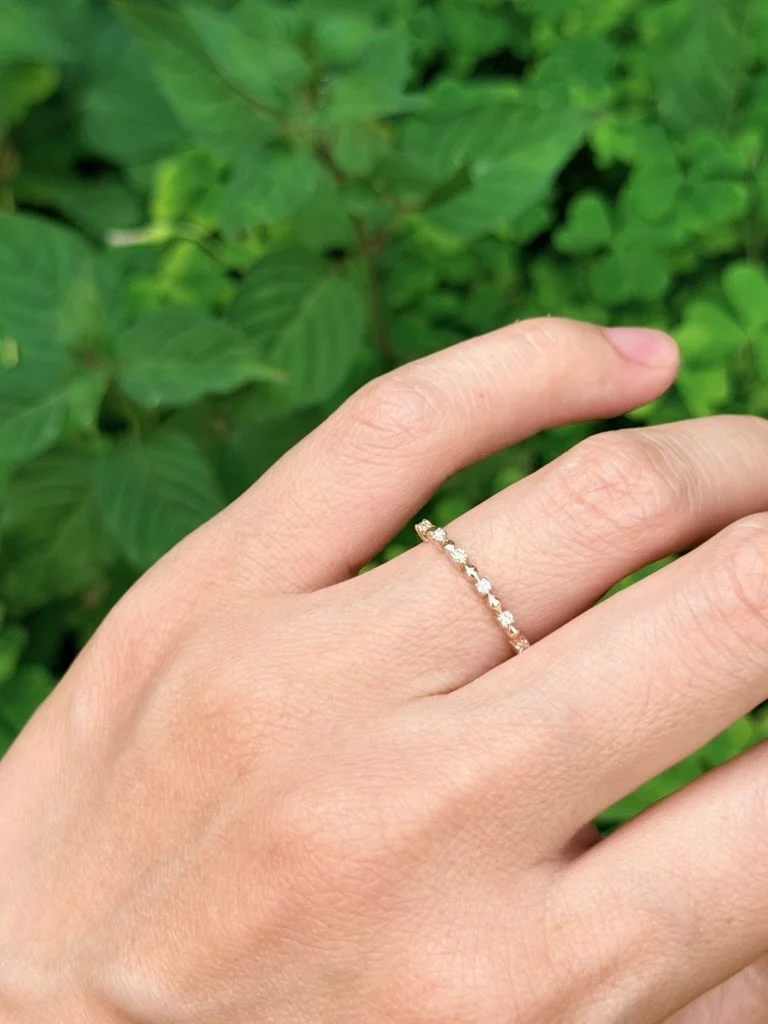 Round lab-grown diamond ring in 9ct yellow gold worn on the hand — round brilliants alternating with geometric gold accents. Gugunava Jewelry, London.