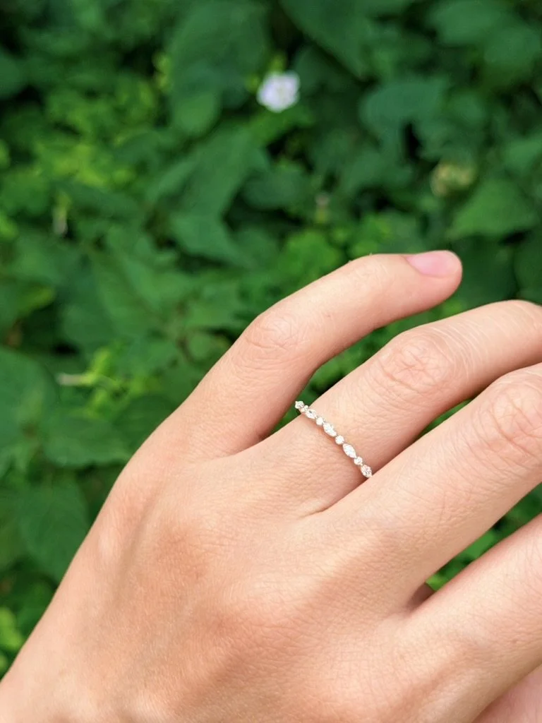 Marquise eternity lab-grown diamond ring in 9ct yellow gold worn on the hand — east-west marquise alternating with round brilliants. Gugunava Jewelry, London.