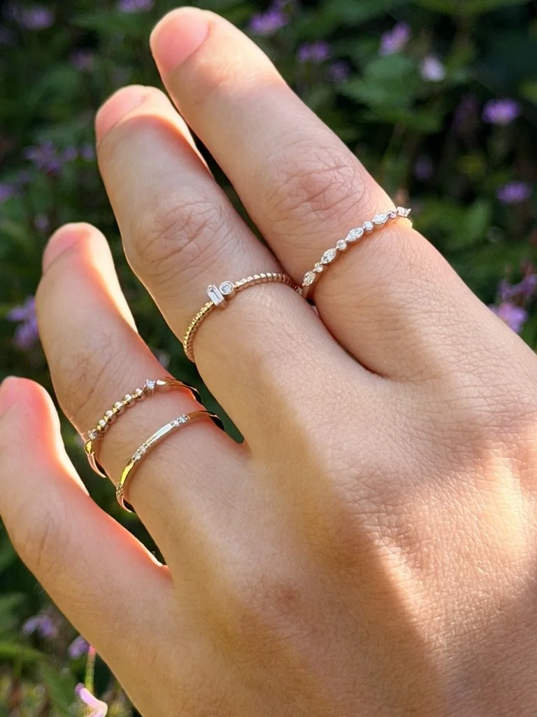 Close-up of a two stone lab-grown diamond ring in 9ct yellow gold — a baguette and round brilliant set side by side on a beaded band. Gugunava Jewelry, London.