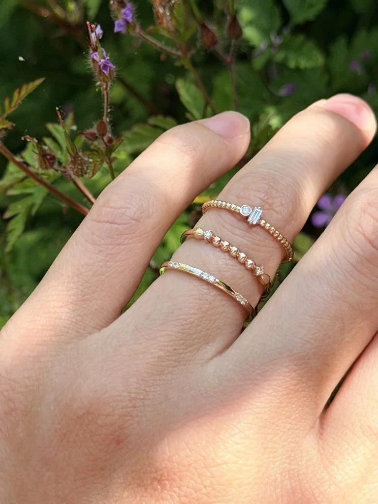 Beaded lab-grown diamond ring in 9ct yellow gold worn on the hand — a row of gold beads with a round brilliant at each end. Gugunava Jewelry, London.