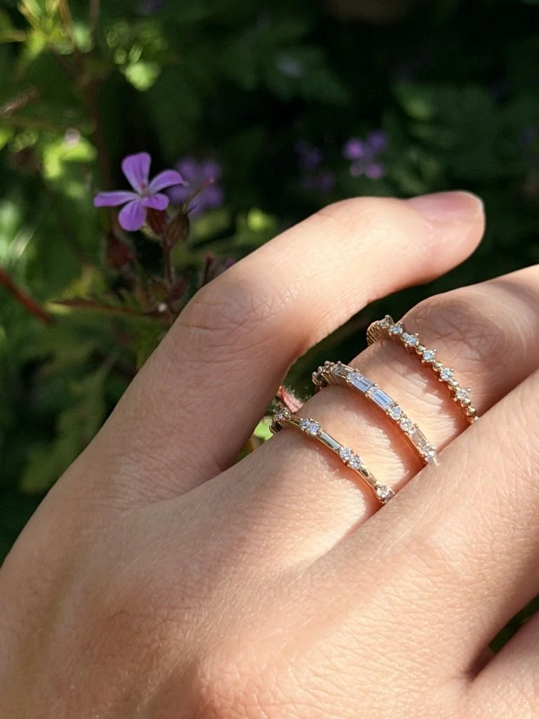 Spaced round lab-grown diamond ring in 9ct yellow gold stacked with other rings from The Minimal Stack Edit, worn on the hand. Gugunava Jewelry, London.