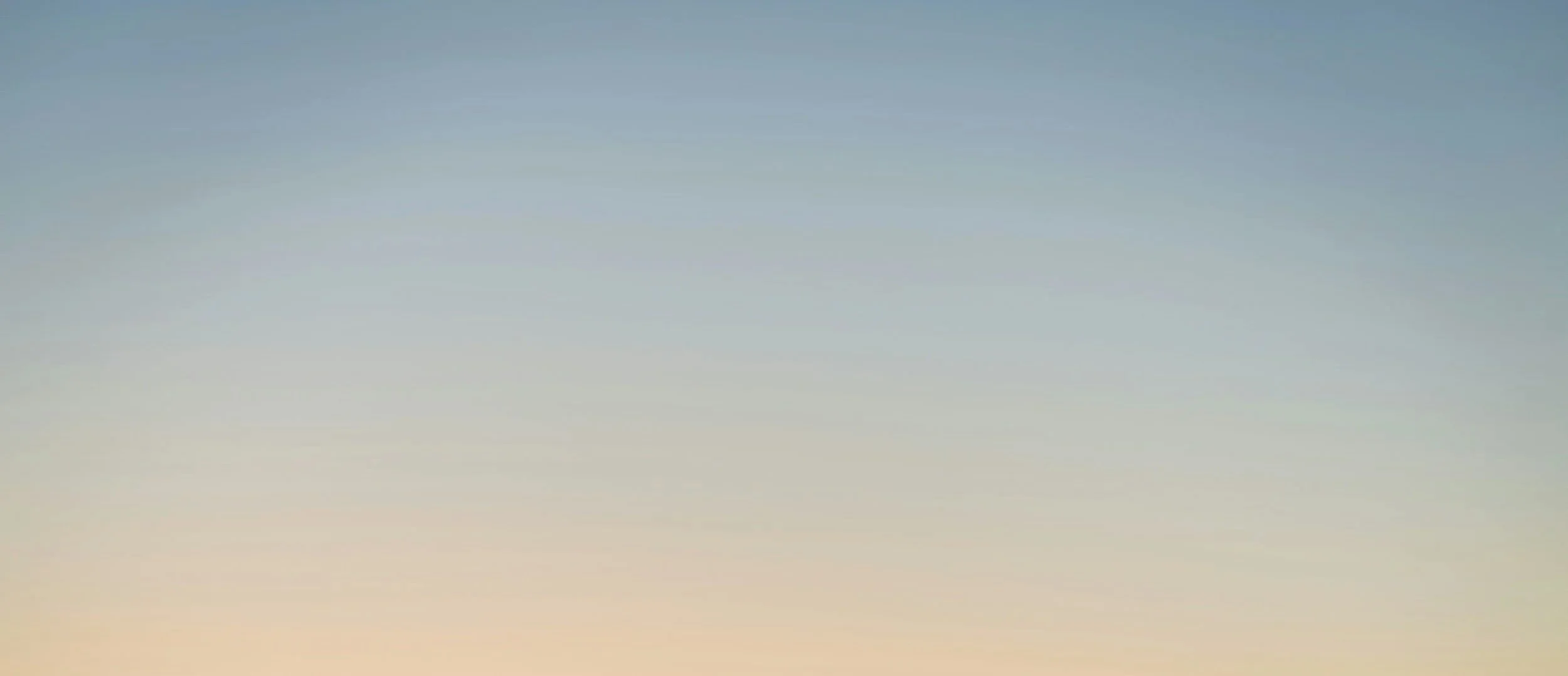 A gradient sky with soft pastel colors, hinting at dawn or dusk.