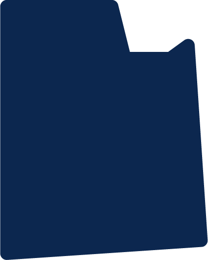 Silhouette of a person sitting on a bench, viewed from behind.