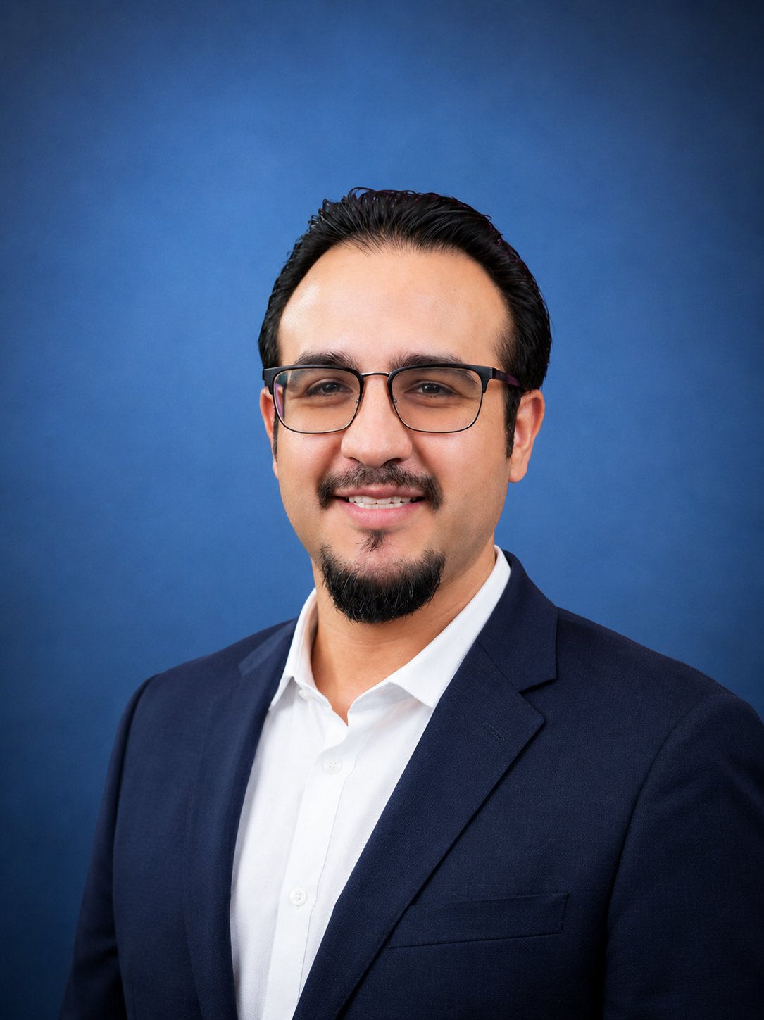 Professional headshot of a man with glasses, a goatee, and a mustache, wearing a dark blazer and white shirt, smiling against a blue backgroundCare Management Green Valley AZ