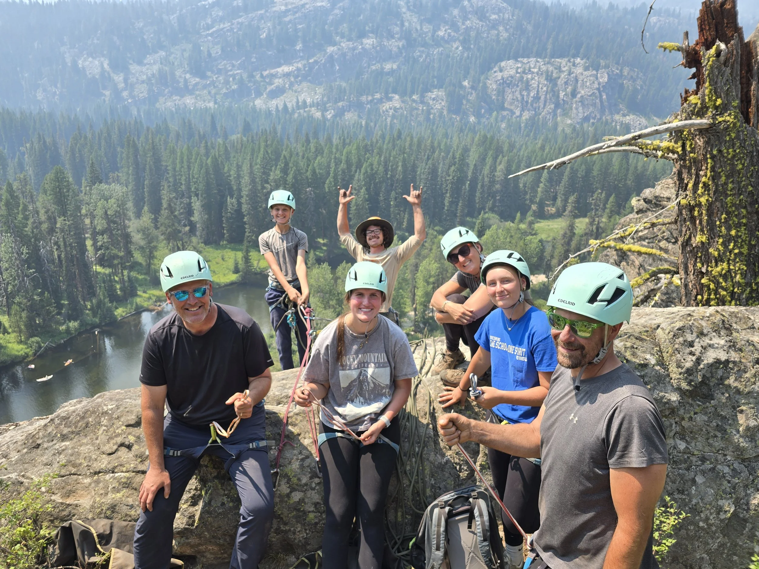 Co-founder Collin is with a smiling family as they all get ready to rappel for the first time.