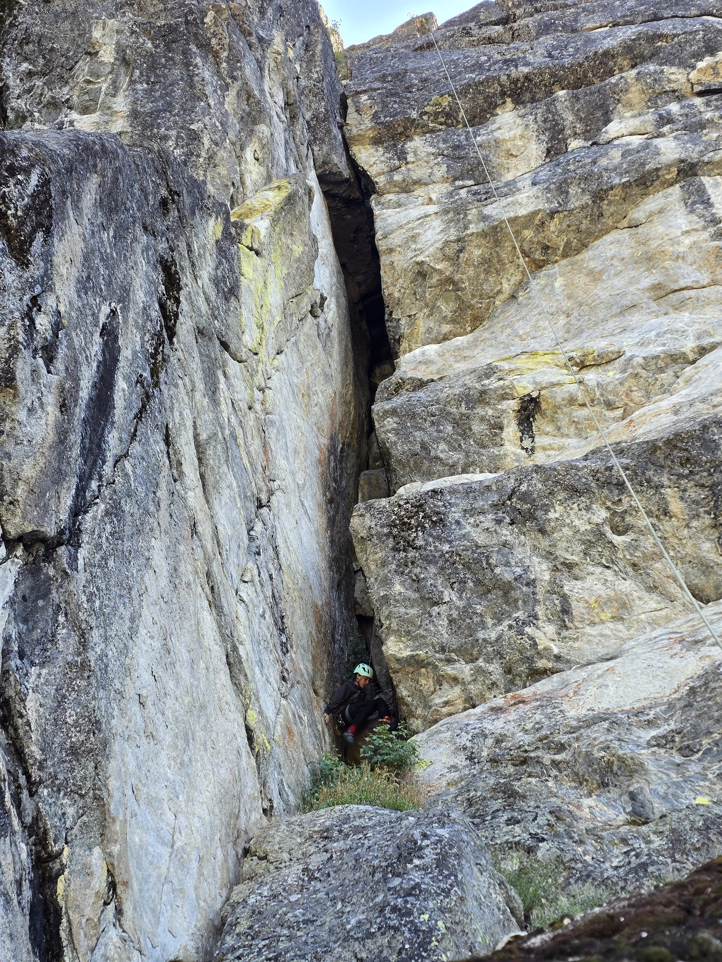 A young club participant begins a climb into a chimney on a route called "Unnamed Chimney"