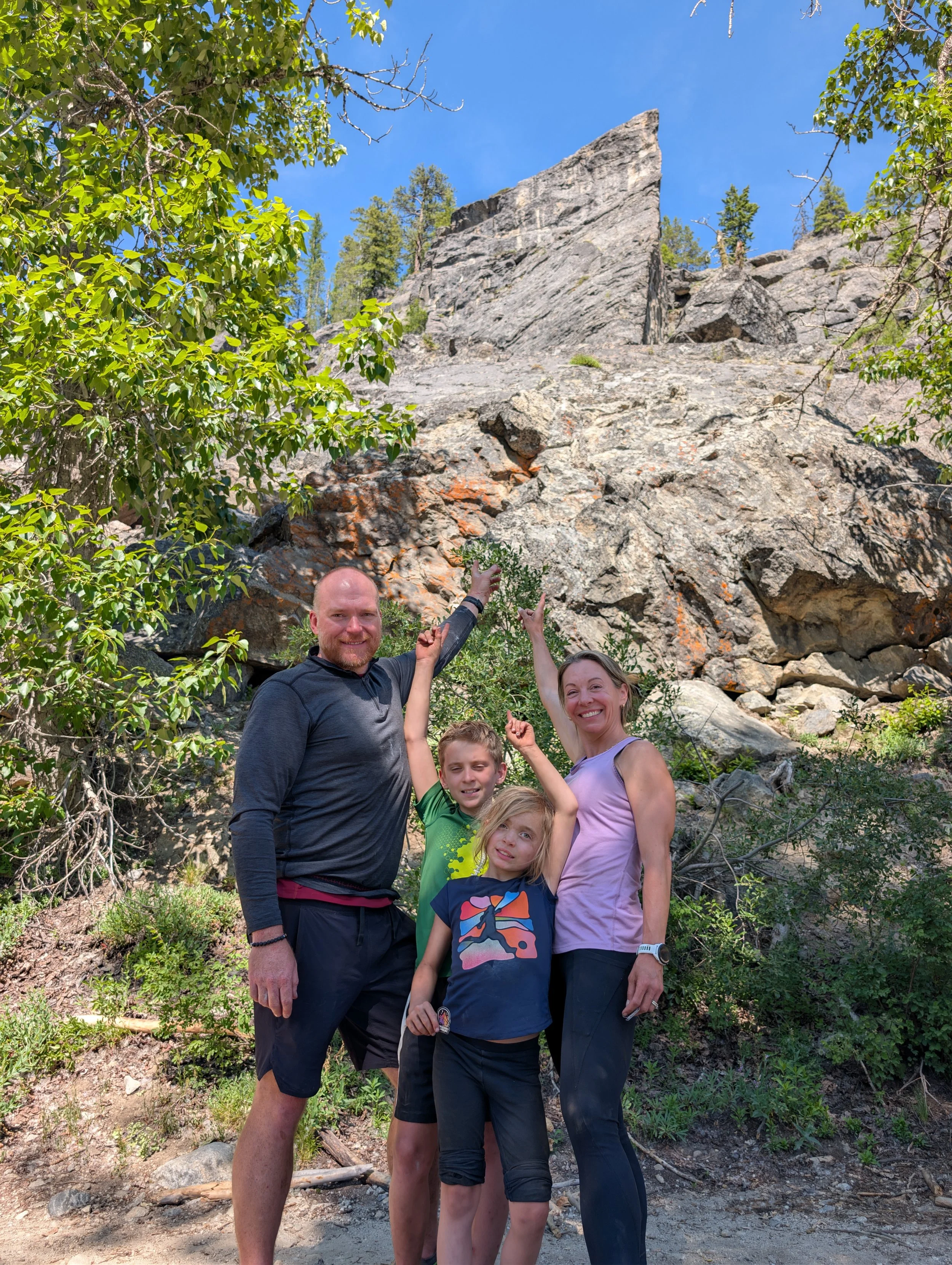 A family points up at The Thinking Spot after a full day conquering the wall.