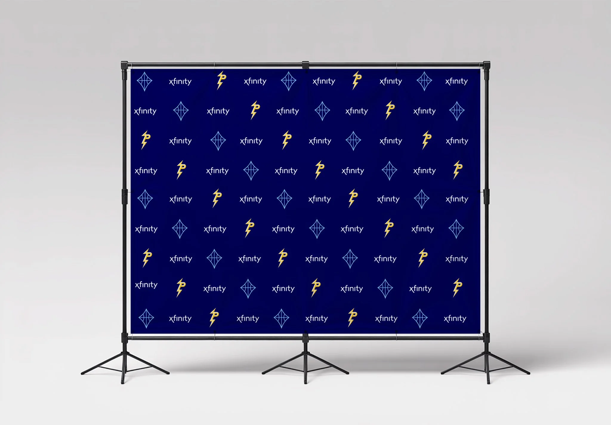 Step-and-repeat backdrop on stands featuring repeating Xfinity text and PHL Freedom lightning and kite logos on a navy background.
