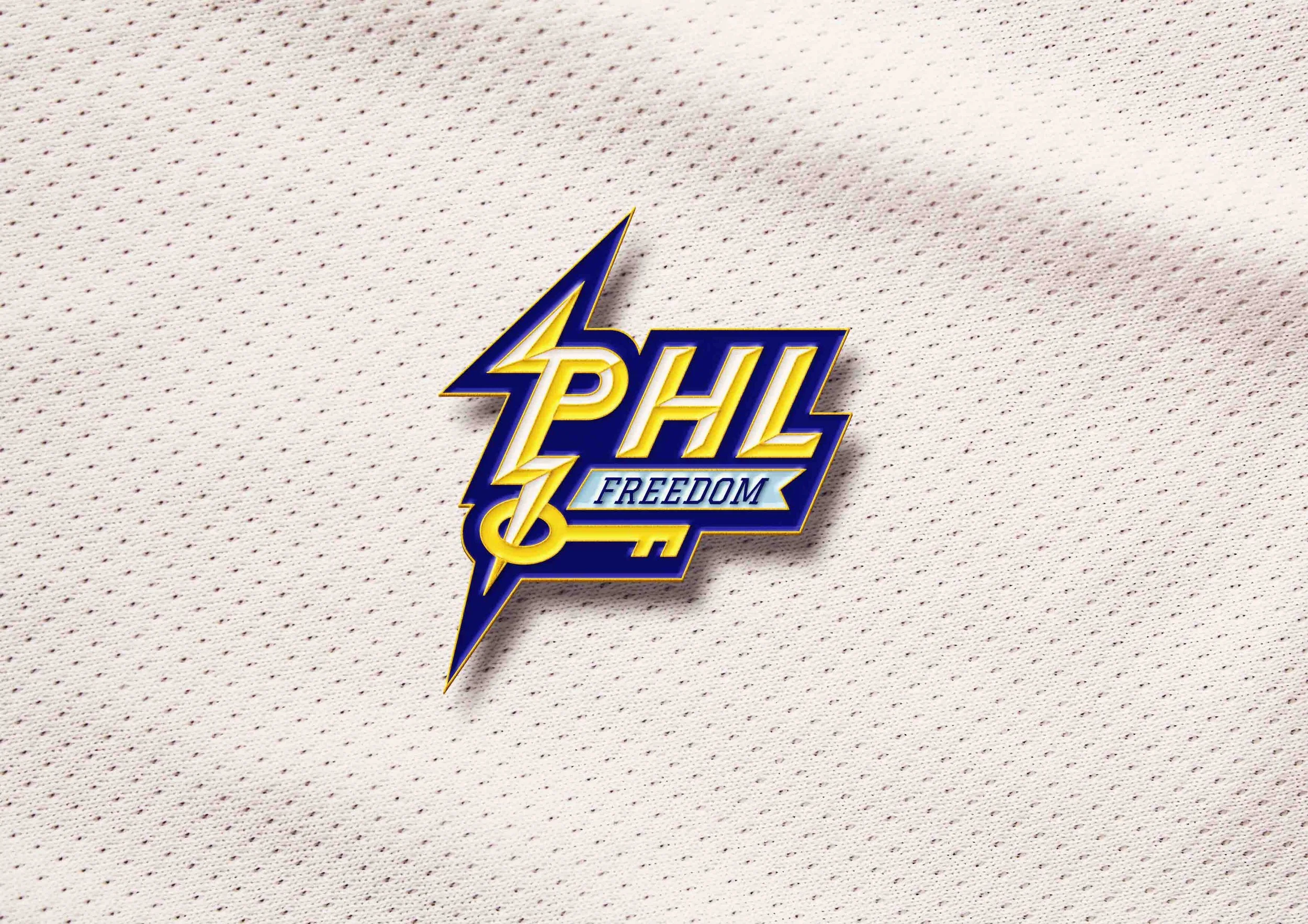 A close-up photo of an enamel pin featuring the Philadelphia freedom logo, outlined in gold metal, set against a plain light gray background.