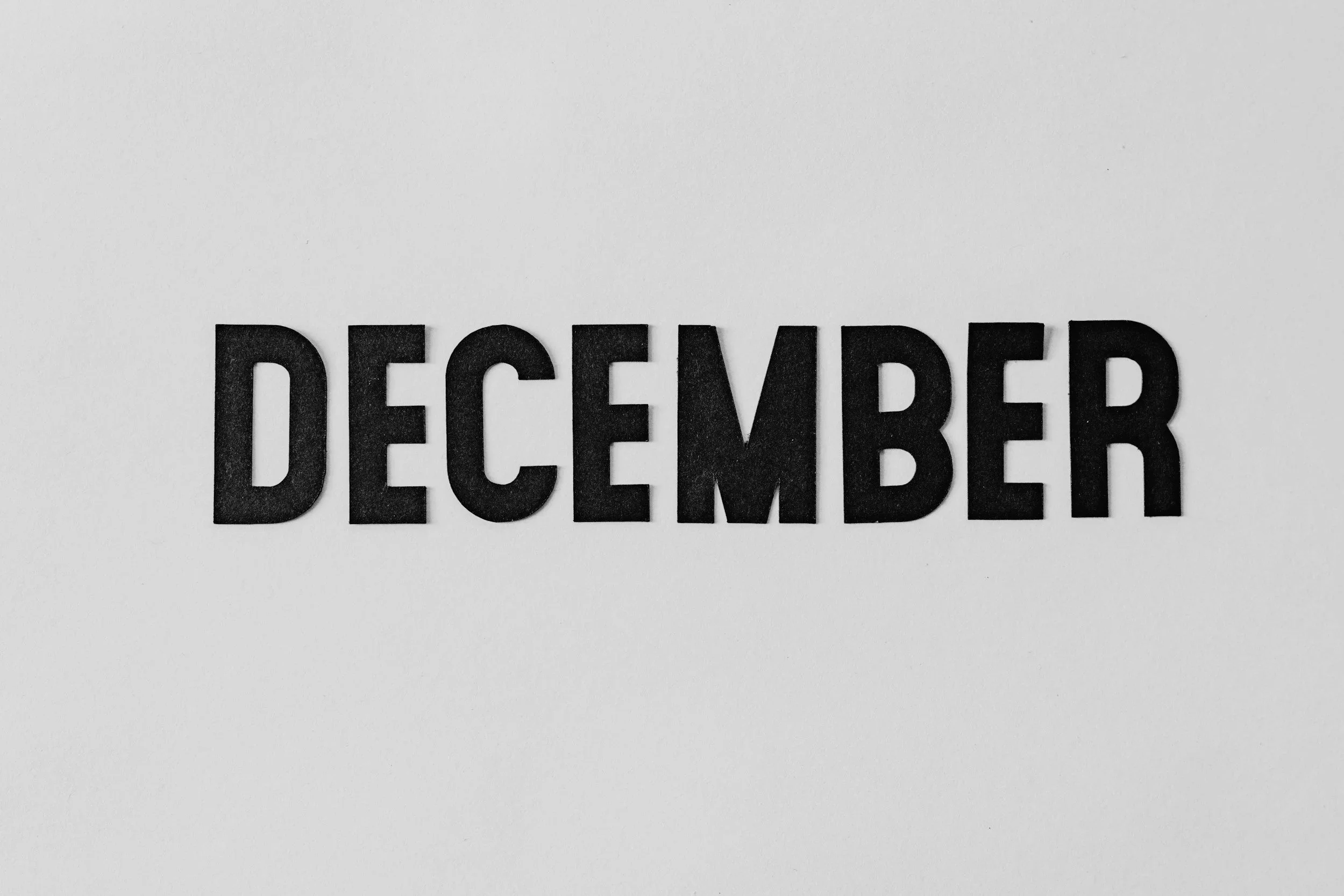 The word 'December' is spelled out in bold black letters on a white background.