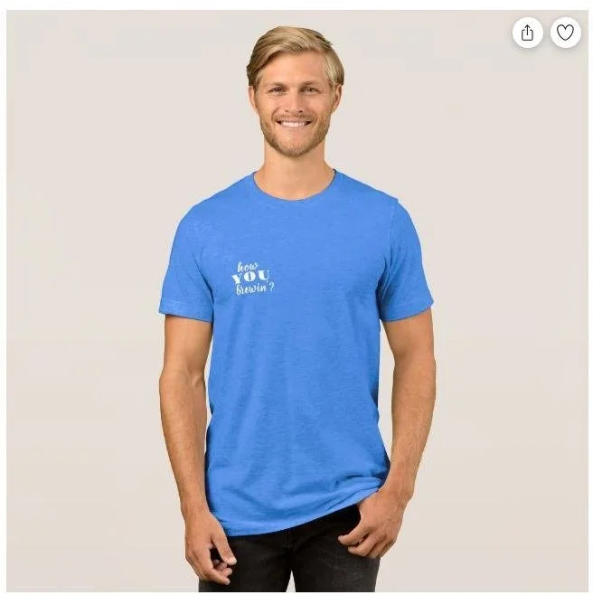 A smiling man with blond hair and a beard wearing a blue T-shirt with white text that says "how do you breathe?" against a plain beige background.