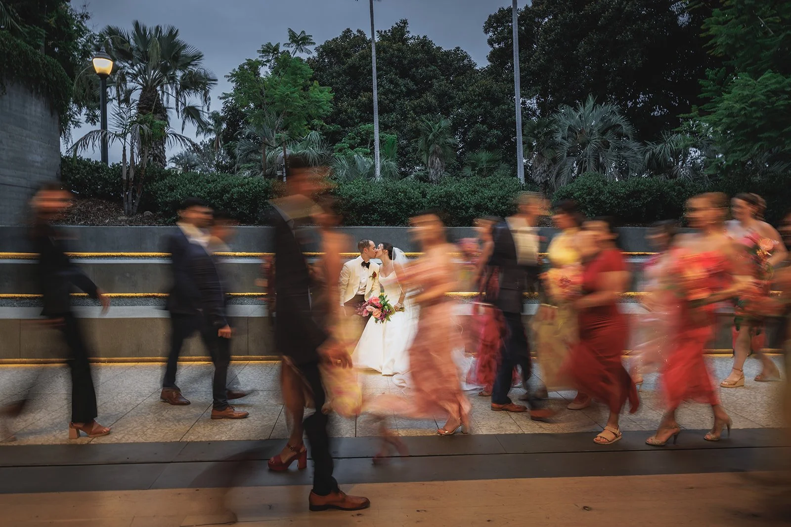 Wedding party walking in motion blur at dusk