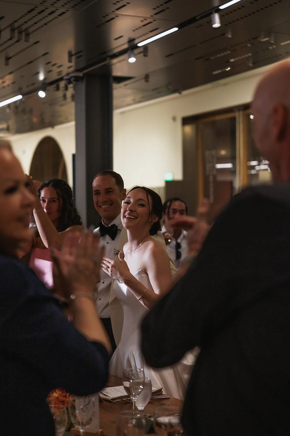 Guests applauding the couple at the reception