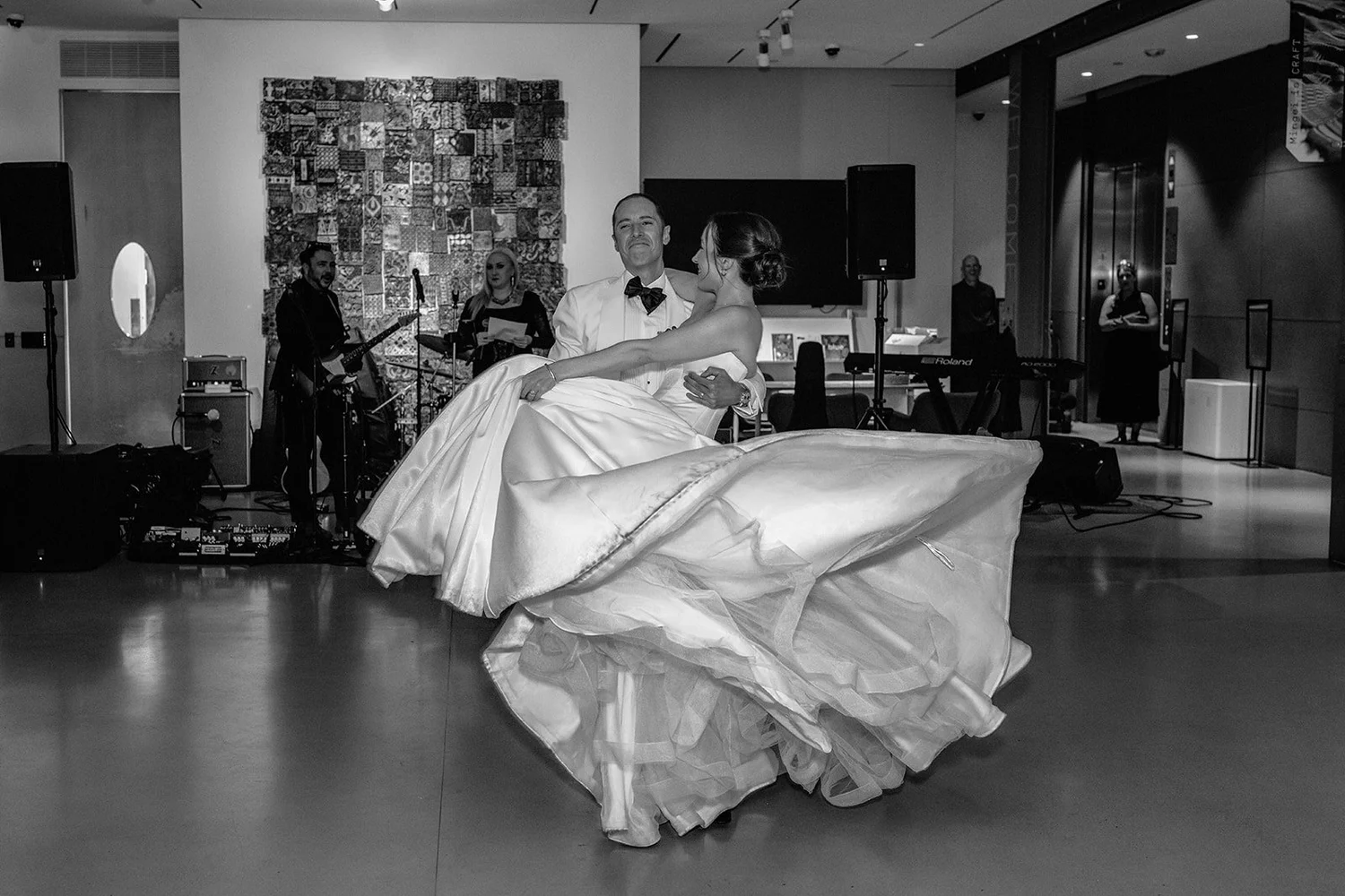 Bride's gown swirling on the dance floor, black and white