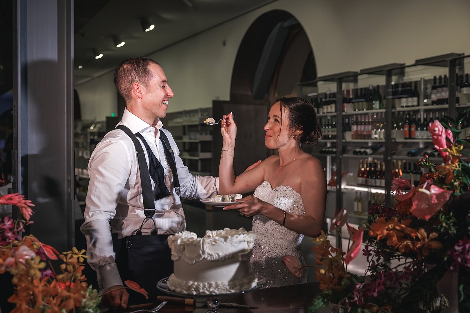 Couple laughing while cutting the cake