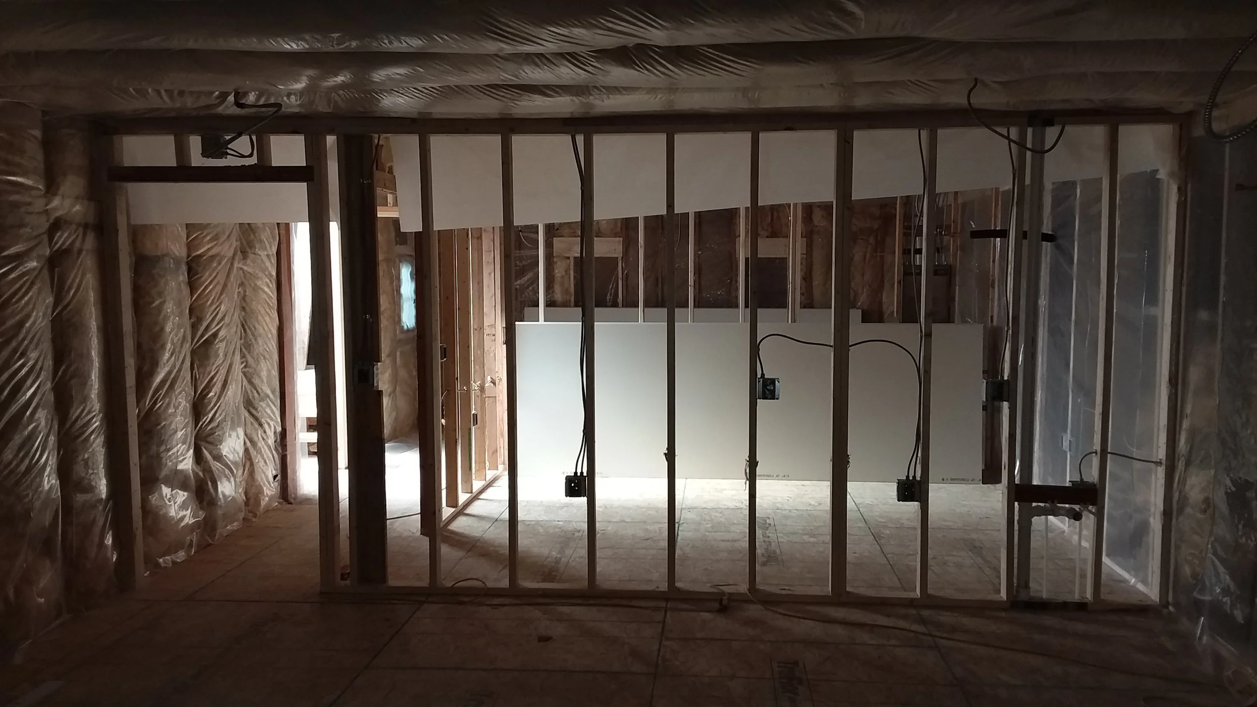 Silhouette of wall framed out with some electrical roughed in. 