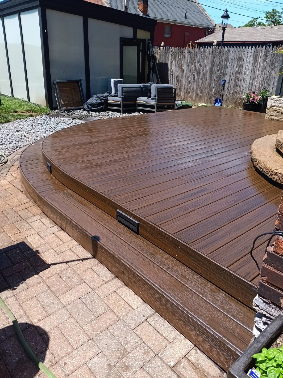 Wooden deck with curved steps, inset Solar lighting and a dark oak stained finish