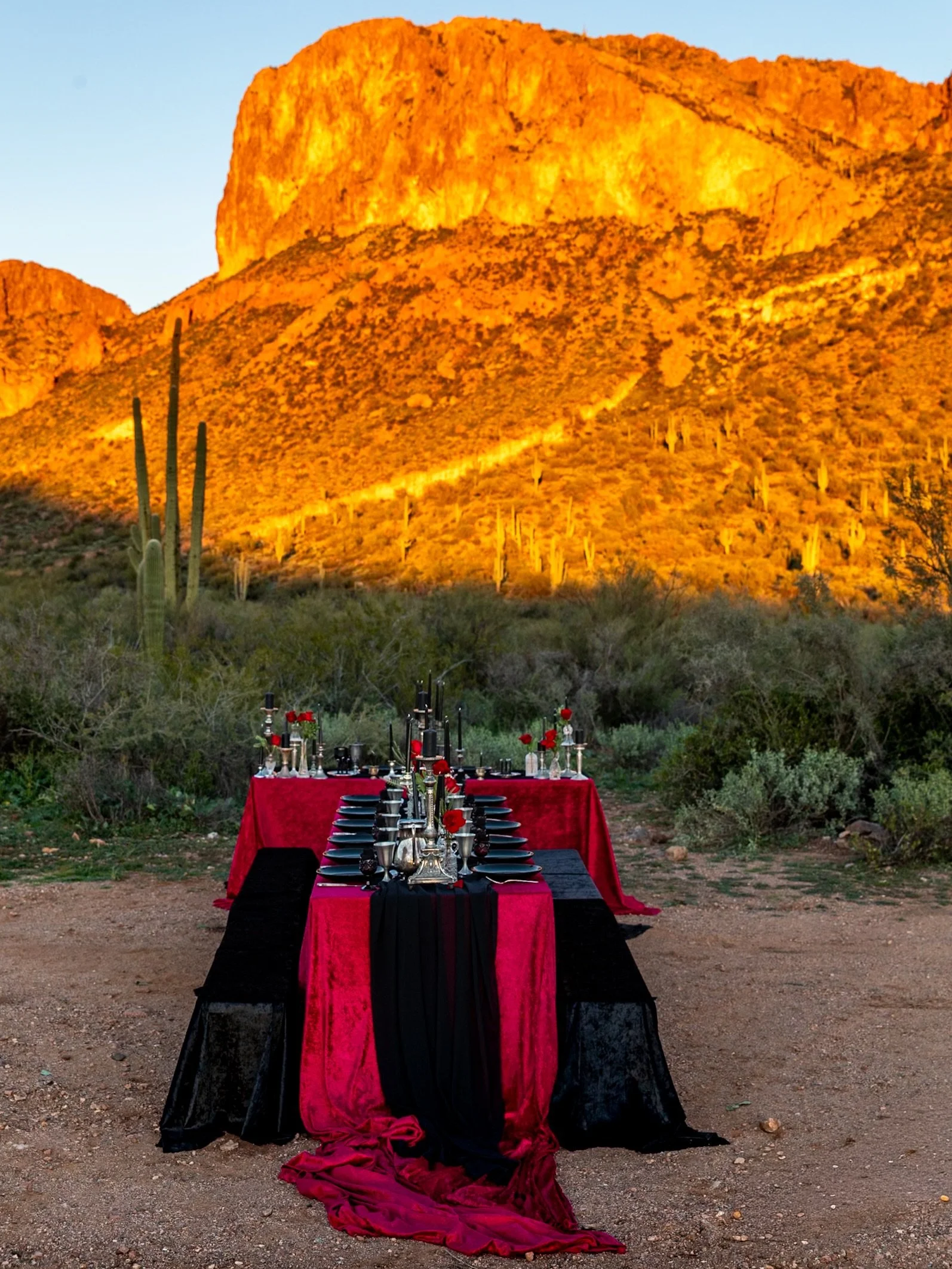 Before our gothic wedding took its final form, there was this.

A crimson table laid in the open desert&mdash;black glass, antique silver and roses burning beneath the mountains.

The first vision, brief and untamed, held by the last light.

#UnderTh