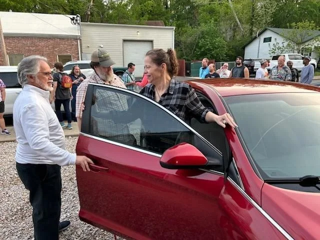 group celebrating receiving a car