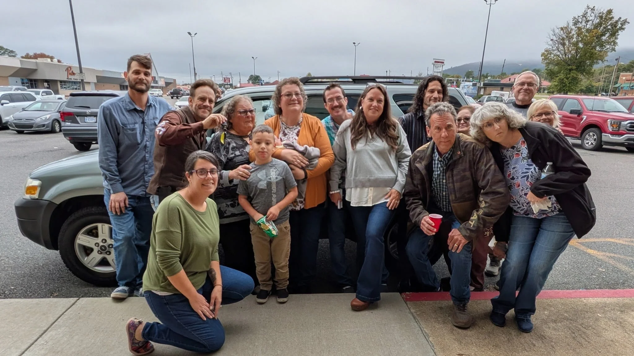 group celebrating receiving a car