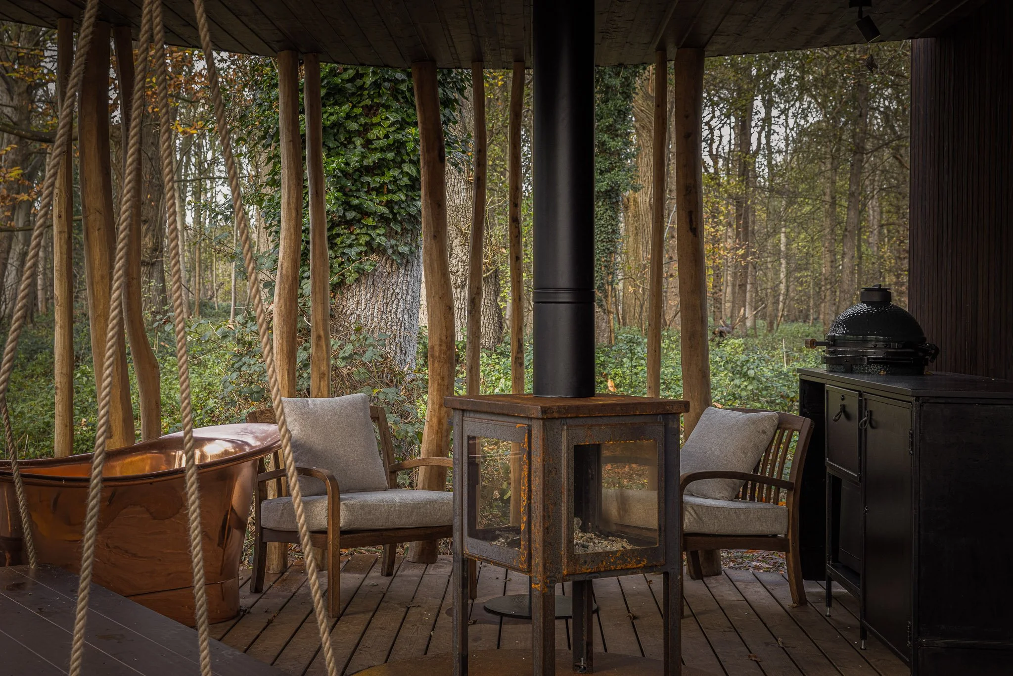 Exterior of cabin featuring outdoor stove and copper bathtub