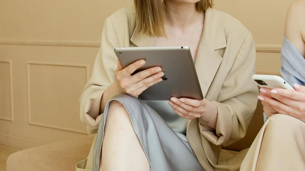 woman business owner holding ipad in meeting