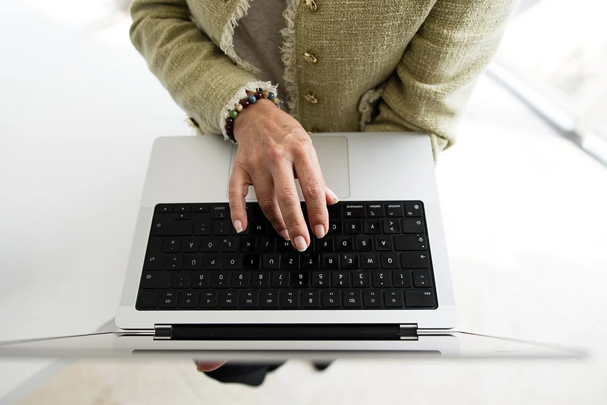 woman's hands on laptop keyboard