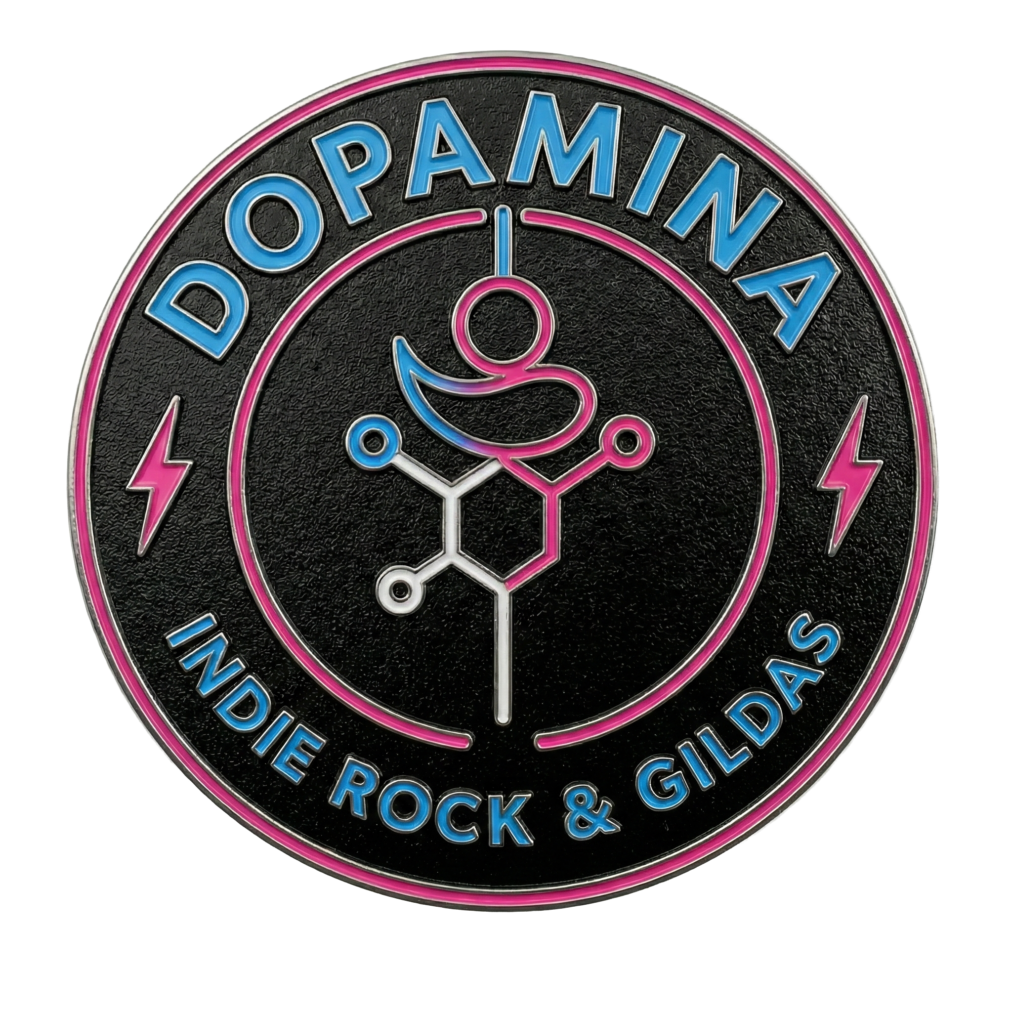Insignia decorativa con palabras 'Dopamina' en la parte superior y 'Indie Rock & Gildas' en la parte inferior, con un símbolo químico en el centro y líneas decorativas en azul, rosa y blanco.
