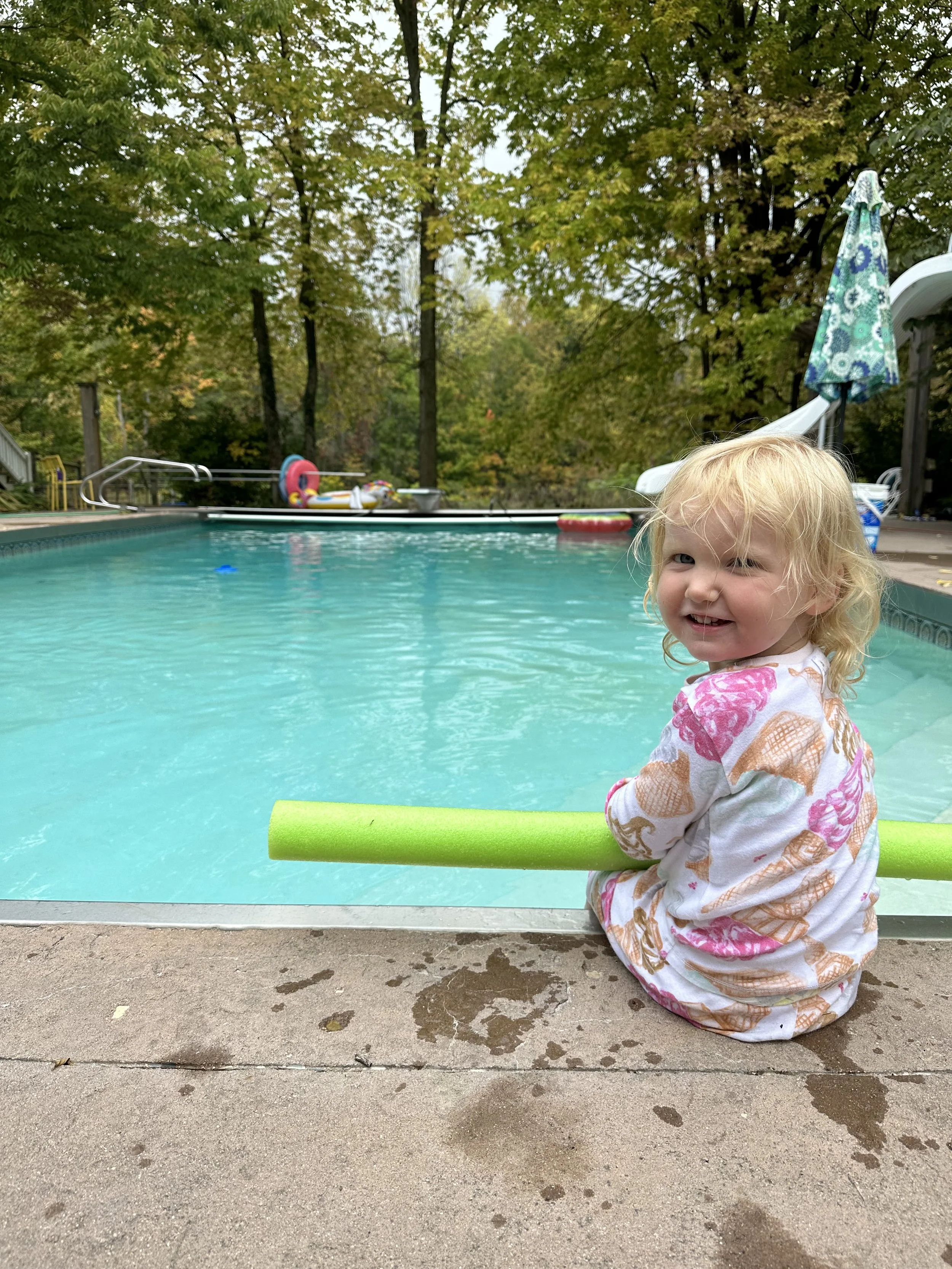 ISR program. Infant swimming resource. a young toddler or child getting ready for their first swim lesson where they will learn to float on their back and breathe until they can be rescued. She is happy and excited for this positive experience