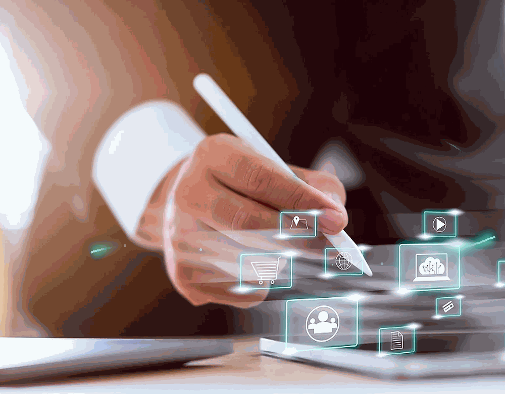 Person using a digital pen to interact with virtual app icons floating above a tablet, representing technology and digital interface.