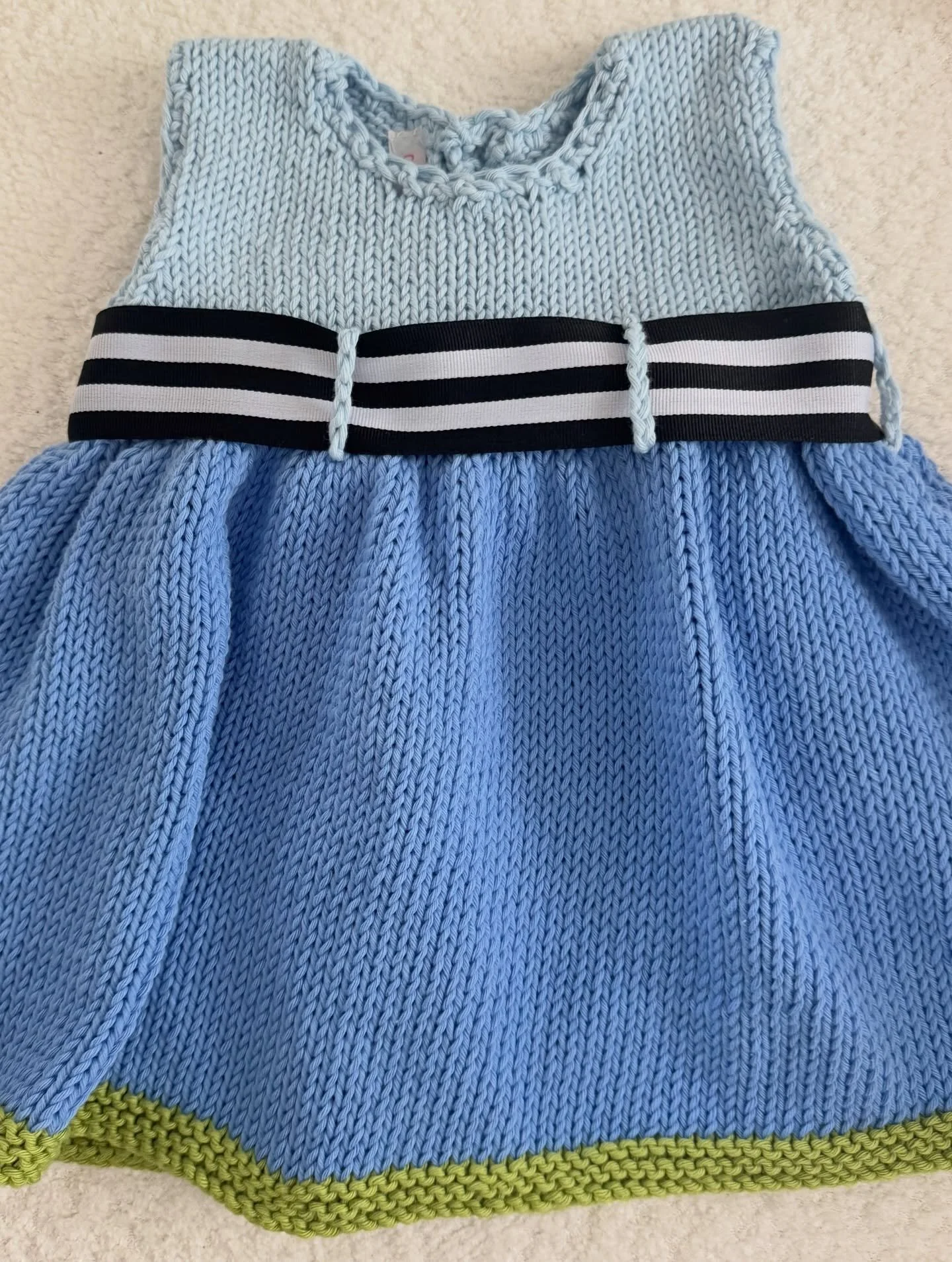 Sweet, classic, and made with so much love 🤍 

This hand-knitted dress in size 12 months is the perfect piece for special moments and everyday charm. Featuring a delicate button-back closure and the sweetest bow detail, it&rsquo;s as beautiful from 