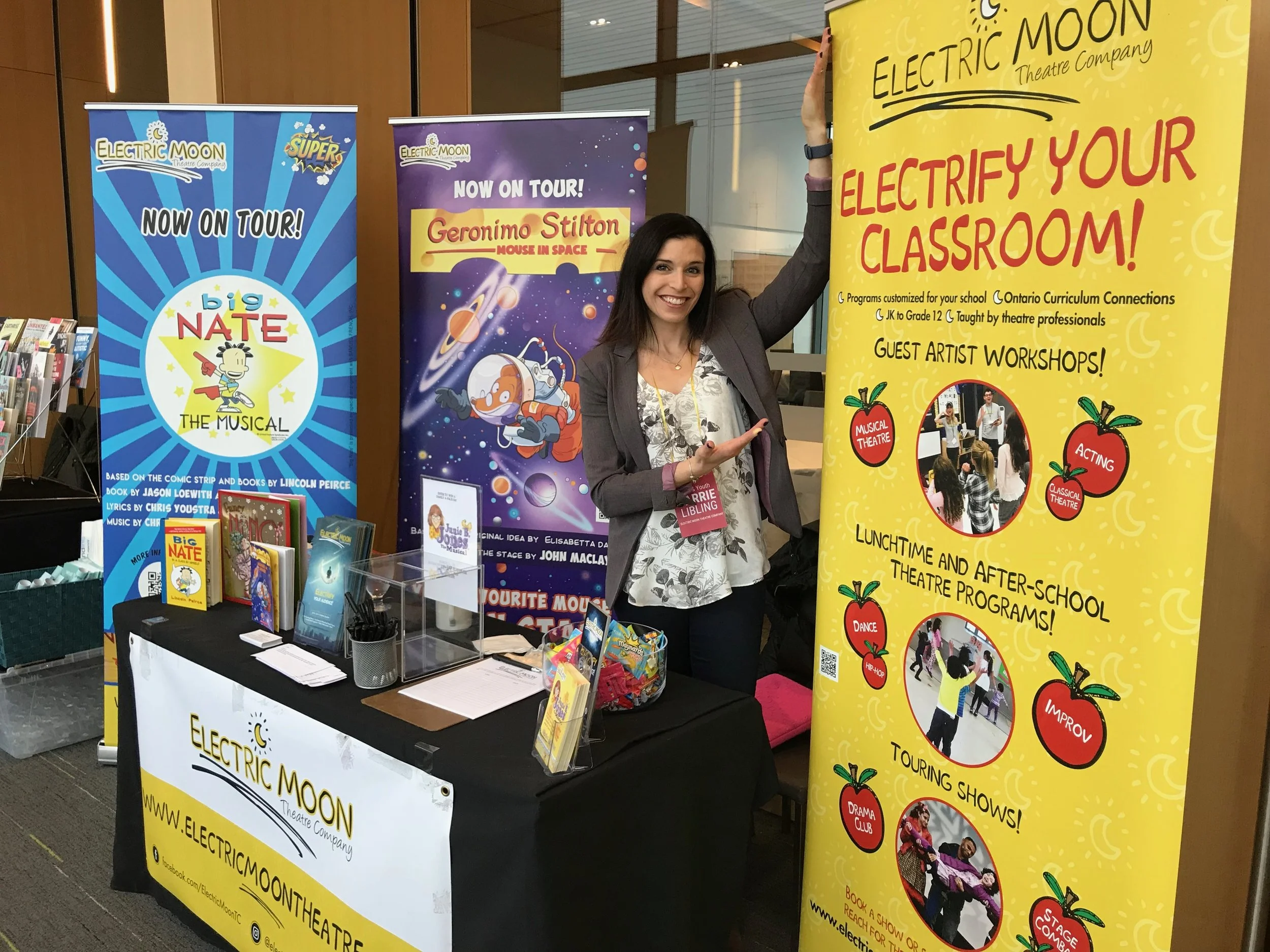 Carrie Libling promoting Electric Moon Theatre Company touring productions and school programs at an event booth.