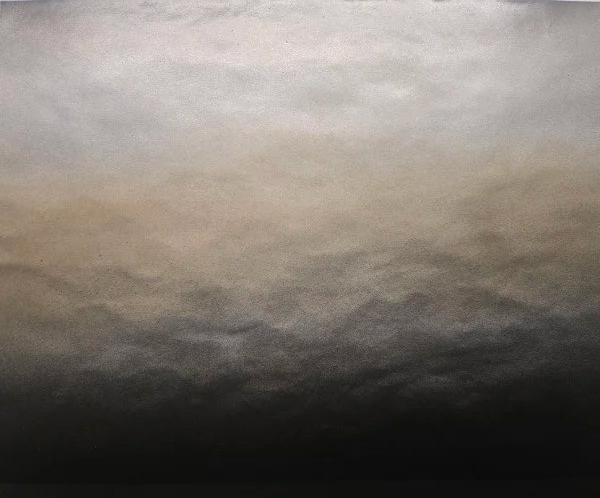 Sky with various shades of gray and some clouds.