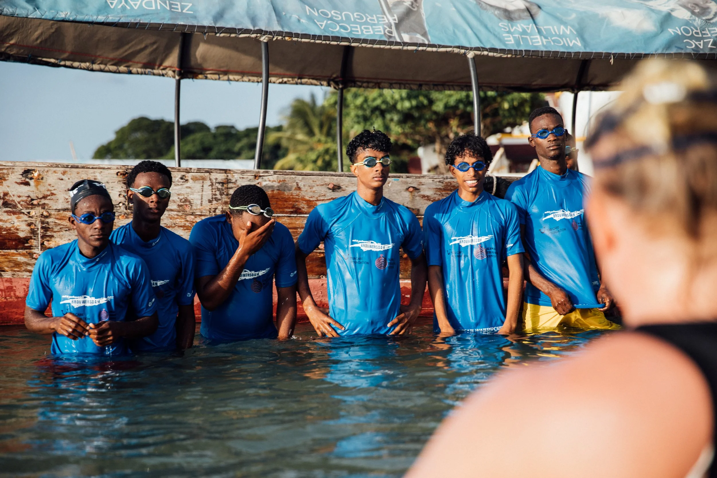 Swimming students in Zanzibar receiving the instruction from Laura swimming coach from Finland on how they can swim better.