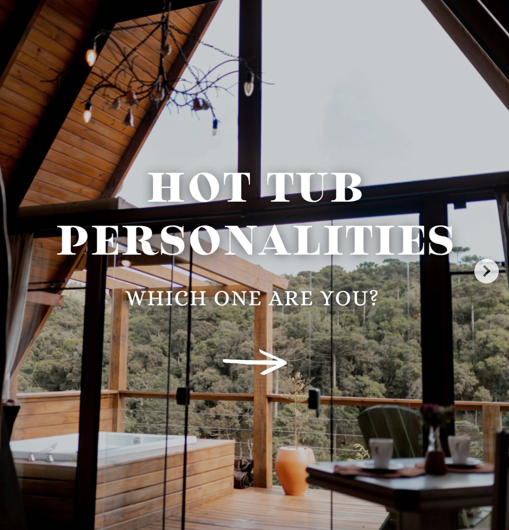A hot tub on a wooden deck with outdoor furniture and string lights, overlooking a forested mountain landscape.