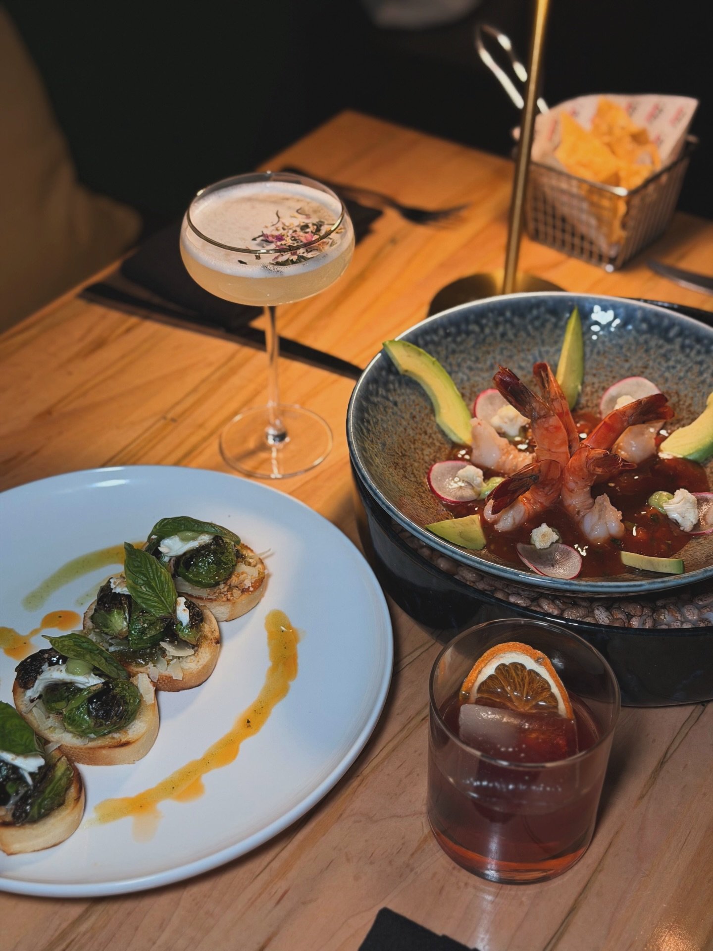 A table full of flavor.✨
Crostinis with roasted Brussels sprouts &amp; burrata foam, and our bold Guatemalan-style Shrimp Cocktail &mdash; both crafted the Enigma way.