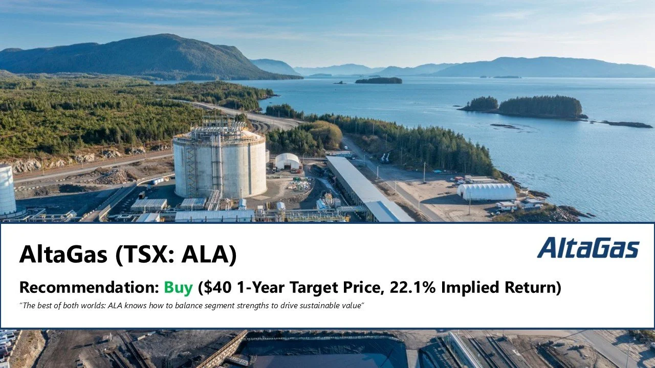 Aerial view of an industrial site next to a large body of water with islands and mountains in the background, featuring storage tanks, pipelines, and construction structures.