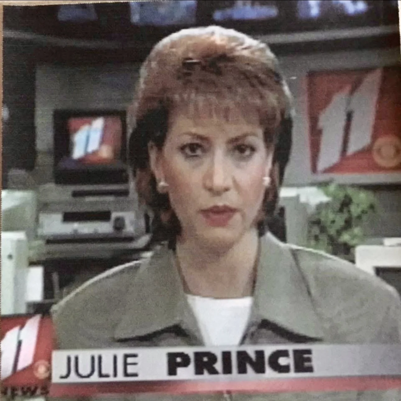 TV screenshot showing a woman with short, brown hair wearing a gray jacket, with a caption reading "Julie Prince" at the bottom.